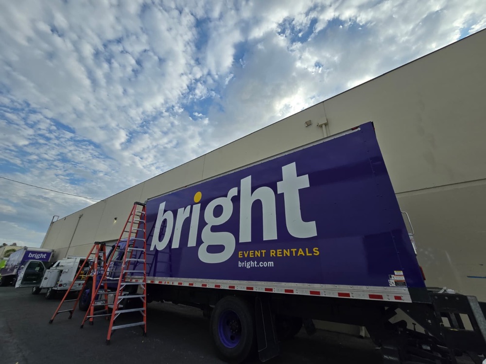 Finished purple box truck with the full bright event rentals lettering, ladders still up