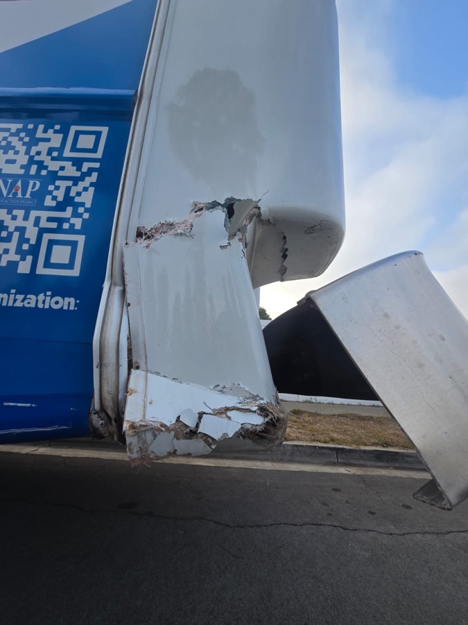 Mobile clinic rear corner torn open with the bumper bent and hanging