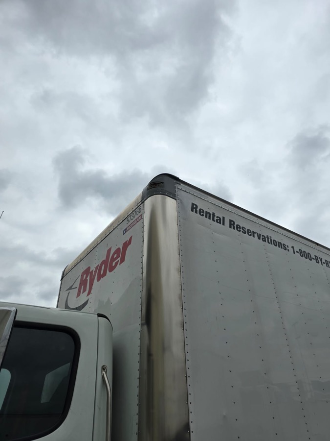 Box truck corner rebuilt with a new panel and cap
