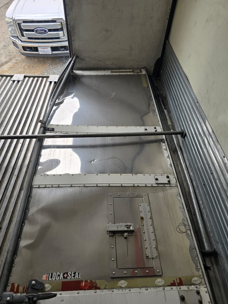 Inside of the damaged rear door, creased and dented across the panel