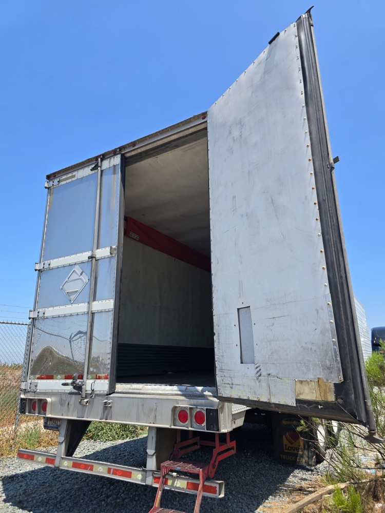 Trailer with the new rear door hung and swung open