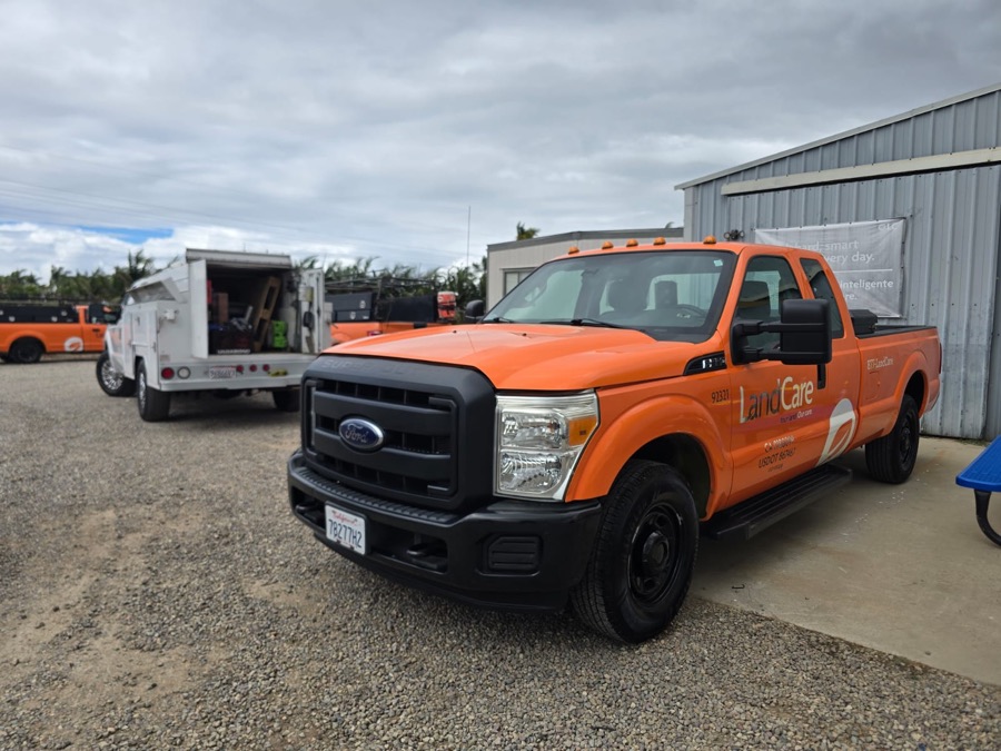 Same F-350 pickup refinished in bright orange, front view