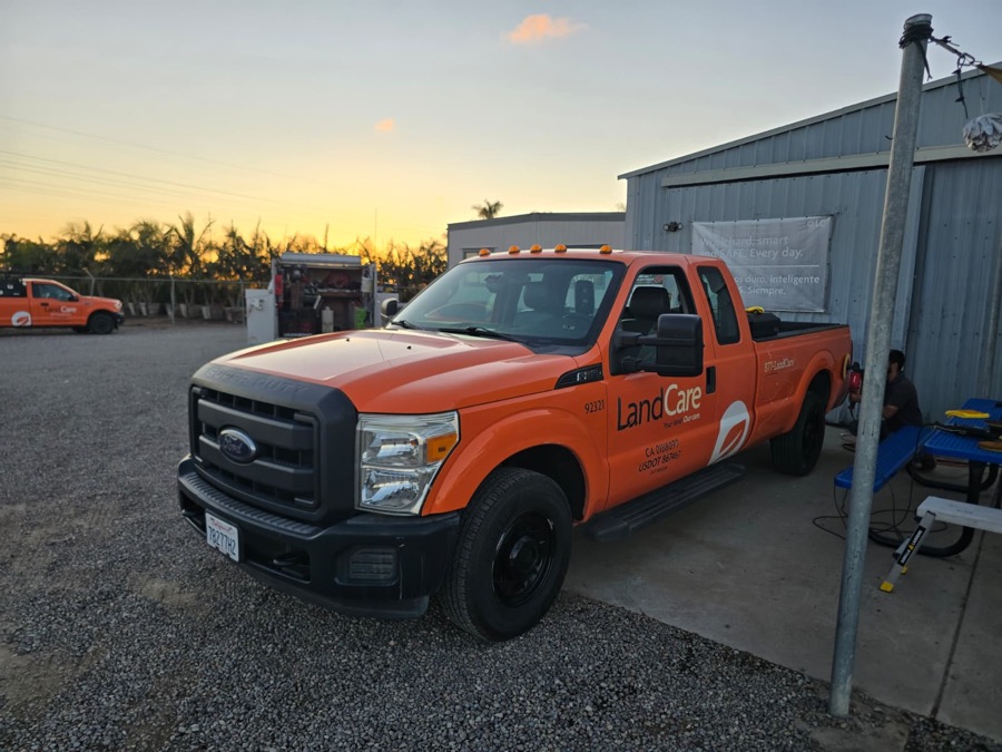Refinished orange F-350 pickup at dusk, front three-quarter view