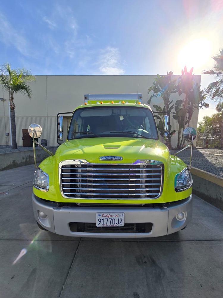Front view of a lime green box truck after body and paint work