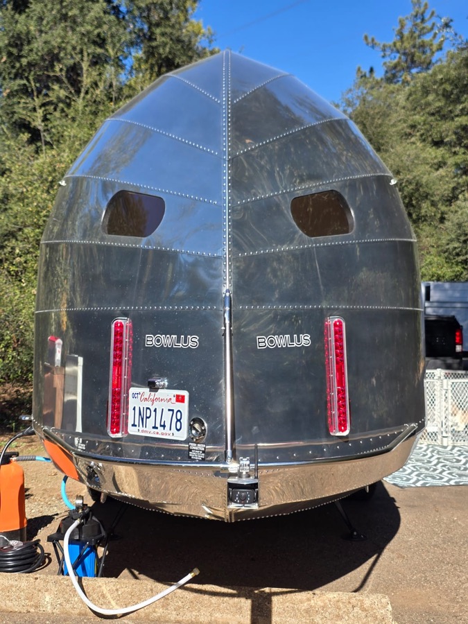 Rear of a polished aluminum travel trailer