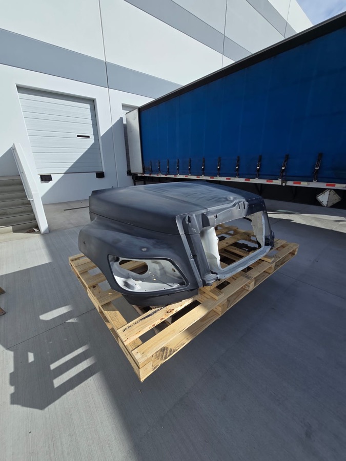 Truck hood with damage on a pallet