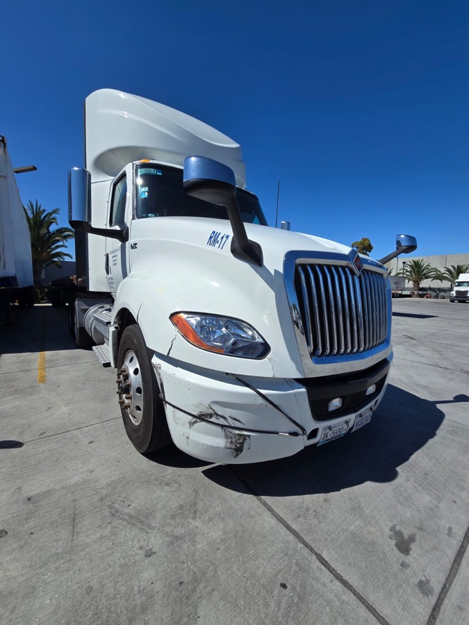 Semi tractor with a scraped bumper and fender