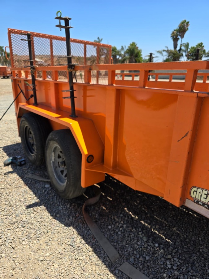 Same orange utility trailer after the fender repair and refinish