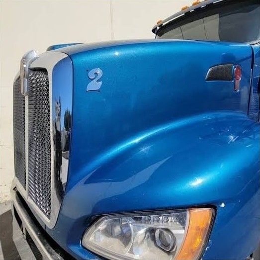 Close-up of the finished blue metallic Kenworth hood and grille