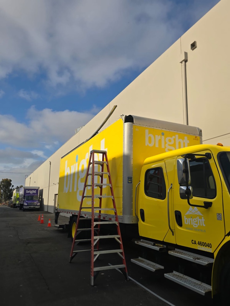 Box truck with the top rail section torn and bent up
