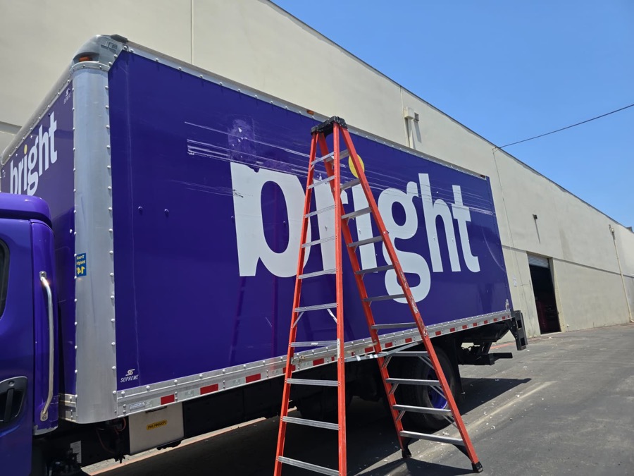 Box truck side scraped and gouged across the lettering and panel