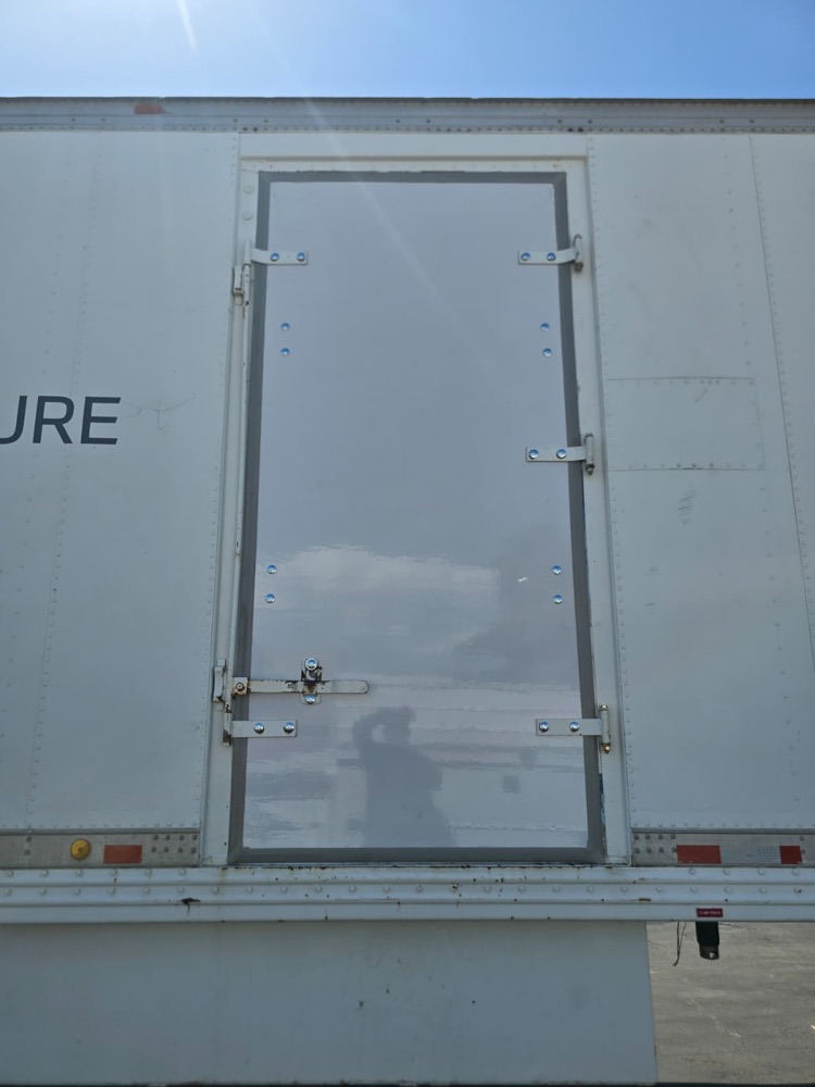 Replaced trailer side access door, straight on, with fresh hardware