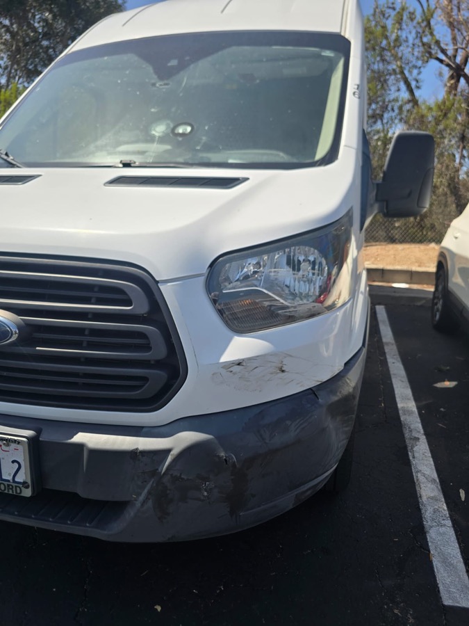 Ford Transit with a damaged bumper and headlight
