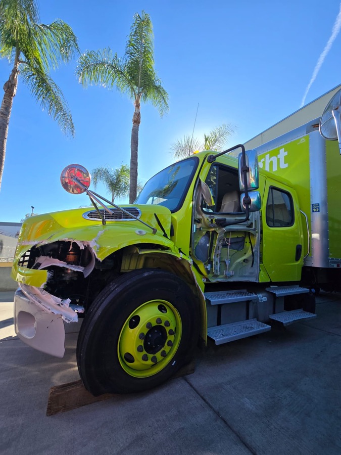 Box truck with crushed fender and hood